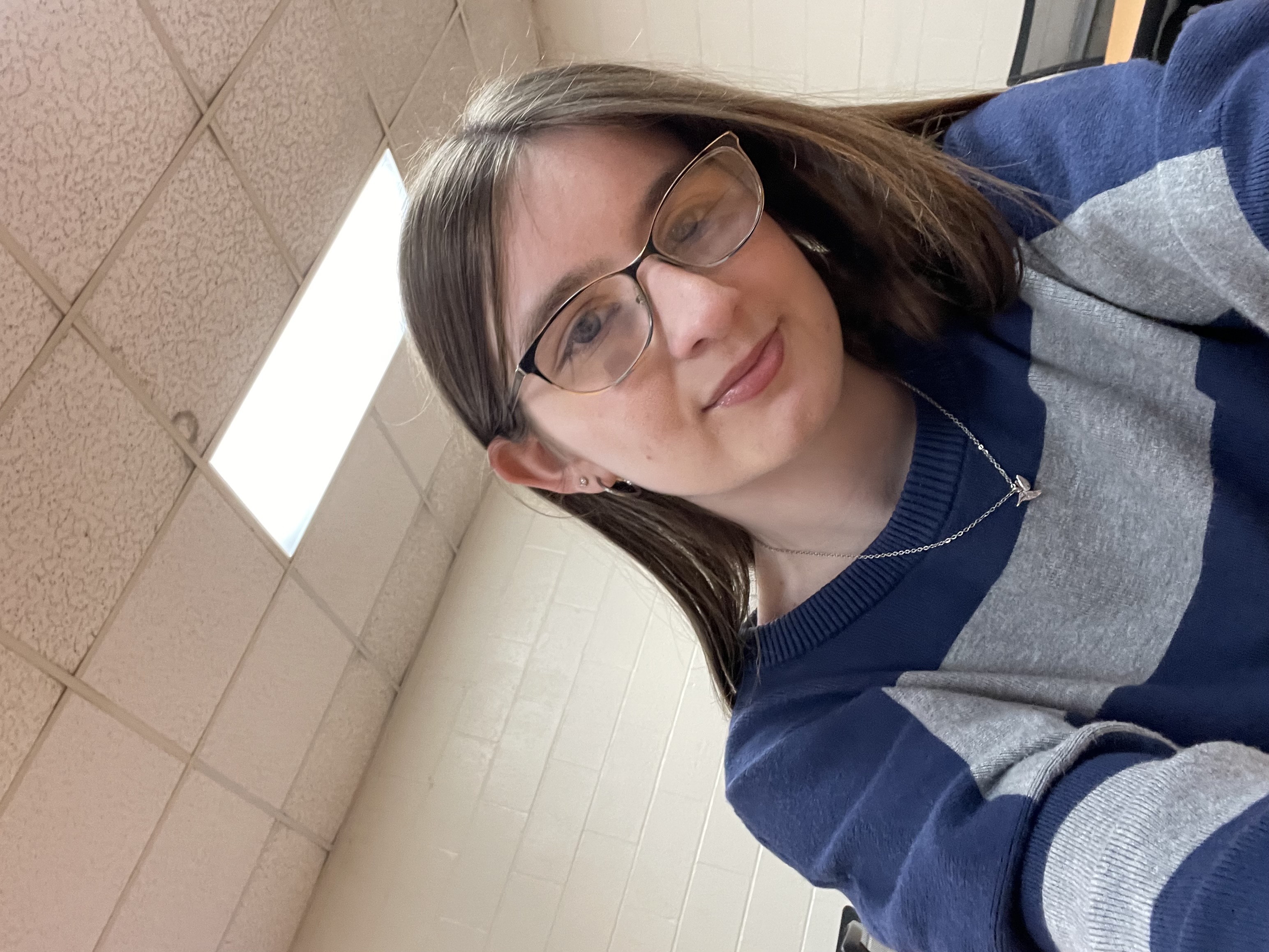 me wearing a blue and grey stripped shirt