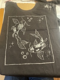 glow in the dark fish design on a black shirt