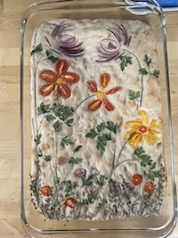 foccia bread with a floral design on it